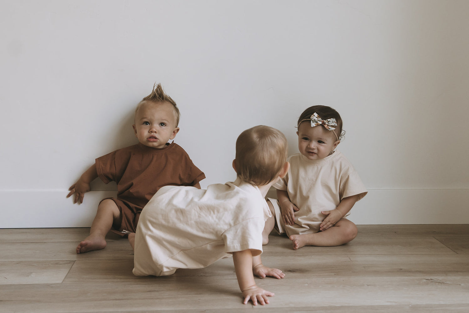 Three Babies in Cotton Rompers